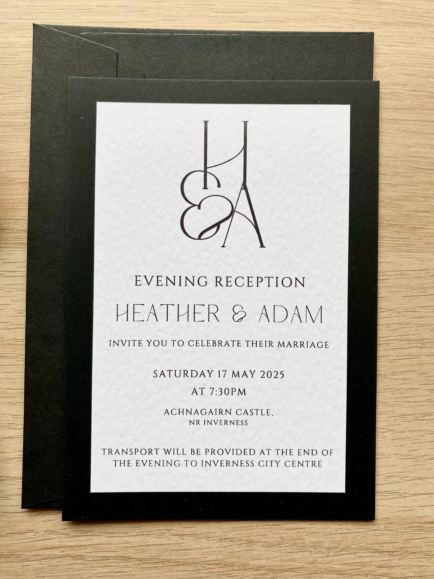 Minimalist wedding reception invitation card, black and white design with modern typography and couple monogram