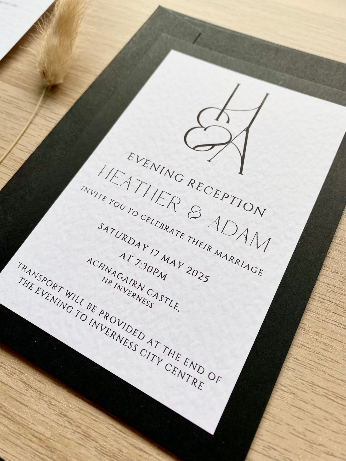 Minimalist wedding reception invitation card, black and white design with modern typography and couple monogram