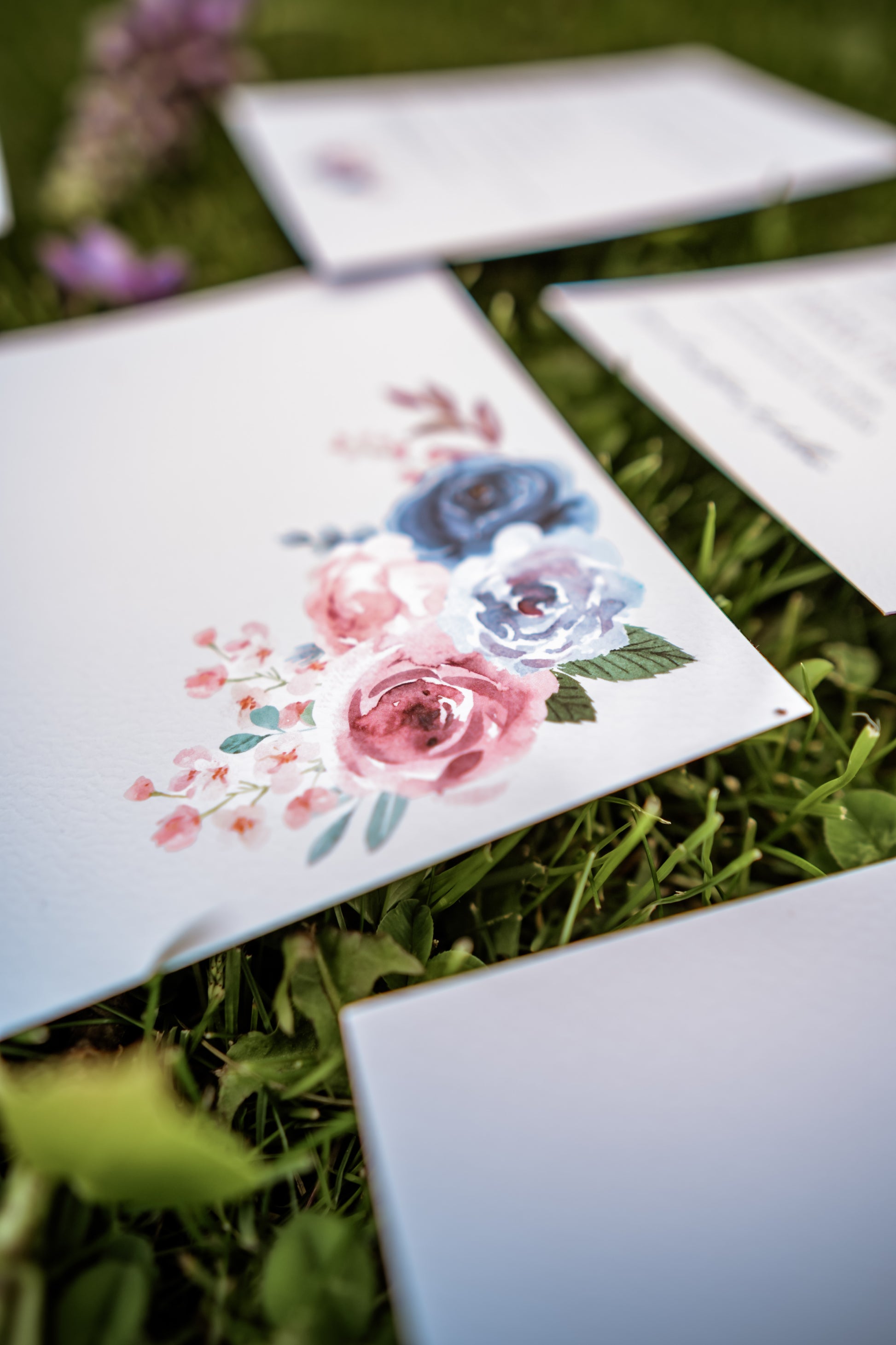 Floral card on grass with envelopes
