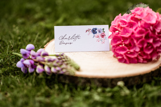 Floral arrangement with a name card on a wooden stump outdoors