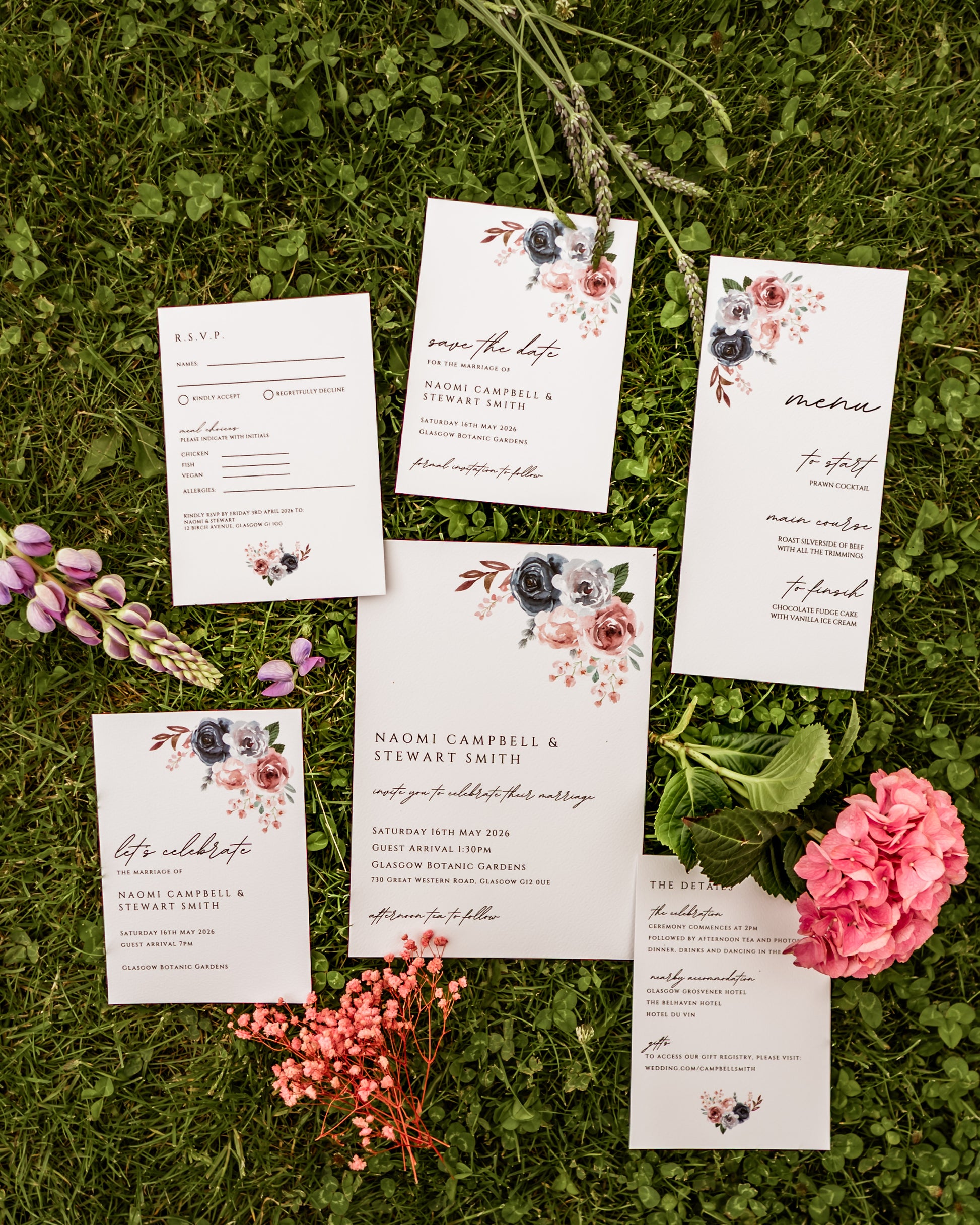 Set of wedding invitations with floral designs on grass